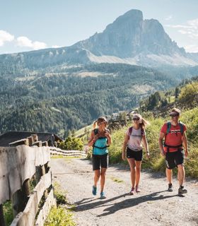 Two women and a man on a hike