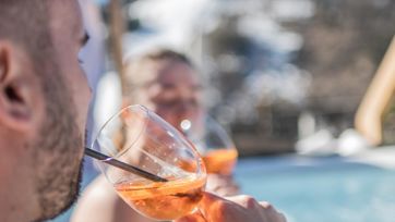 A couple is enjoying an aperitif in the outdoor whirlpool