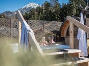 A couple is enjoying an aperitif in the outdoor whirlpool