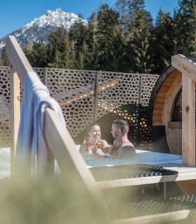 A couple is enjoying an aperitif in the outdoor whirlpool