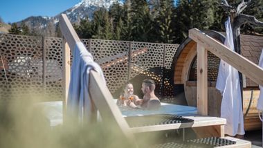 A couple is enjoying an aperitif in the outdoor whirlpool
