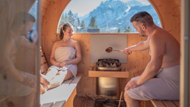 A couple is doing an Aufguss in the sauna