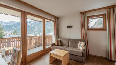 The sitting area and the balcony of one of the rooms